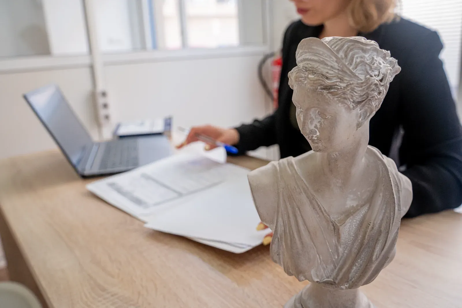 The office meeting table, with Miriam Acerete reviewing a file